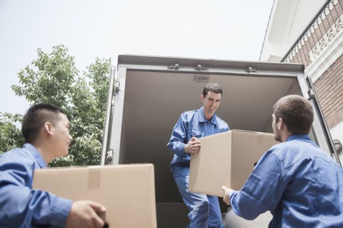 Professional moving team handling household items during an Eltham removal